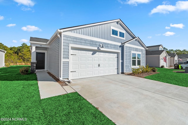 view of front of property with a garage and a front yard