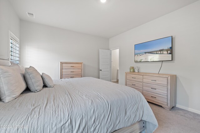 bedroom featuring light colored carpet