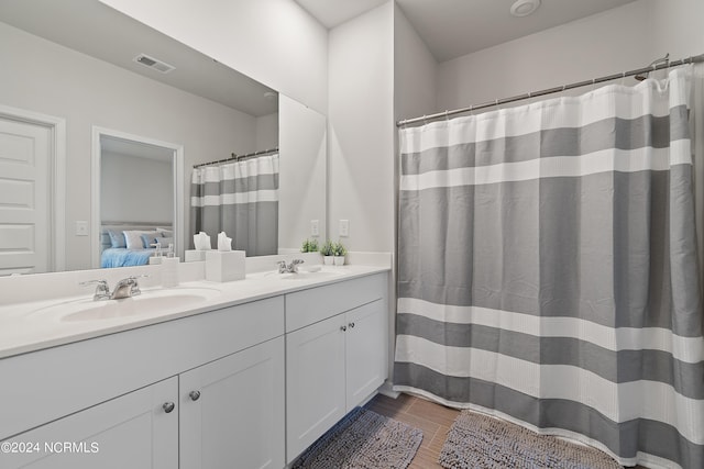 bathroom with hardwood / wood-style flooring and vanity