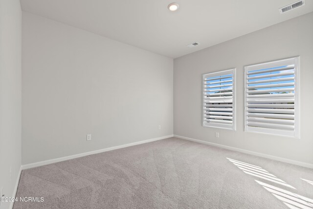 spare room with light colored carpet