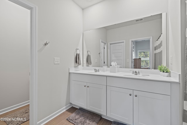 bathroom with vanity and hardwood / wood-style flooring