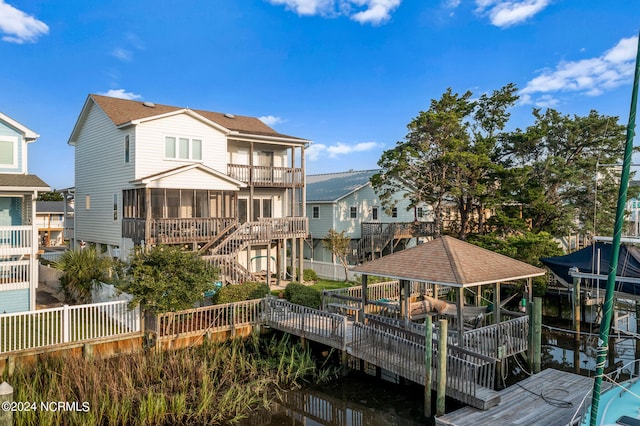 back of house with a balcony and a wooden deck