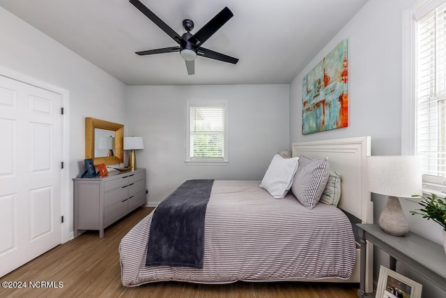 bedroom with ceiling fan and wood-type flooring