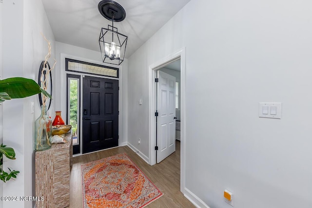 foyer with a notable chandelier and light hardwood / wood-style floors