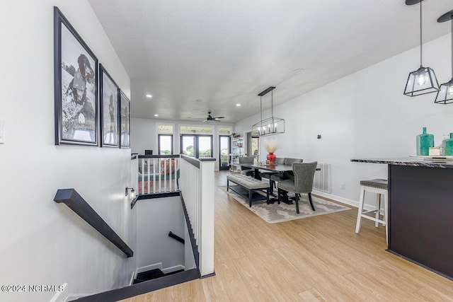 exercise area featuring light hardwood / wood-style floors and ceiling fan