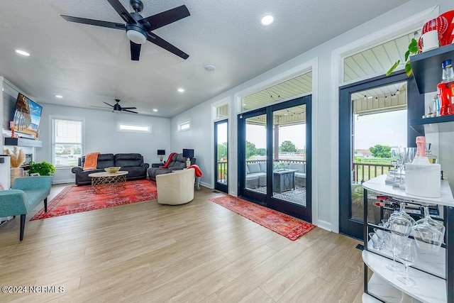 living room featuring light hardwood / wood-style floors and a textured ceiling