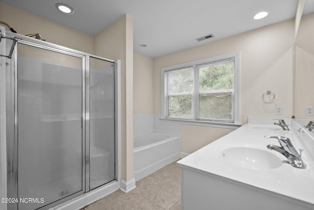 bathroom featuring visible vents, a sink, a garden tub, and tile patterned floors