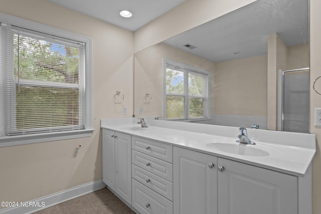 full bath with double vanity, visible vents, a shower with door, tile patterned floors, and a sink