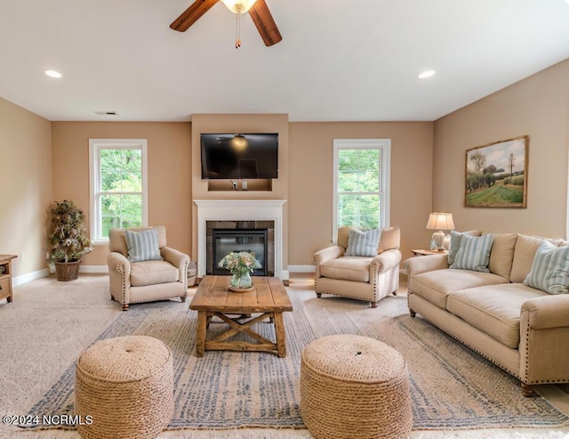 living area with carpet, recessed lighting, visible vents, a glass covered fireplace, and baseboards