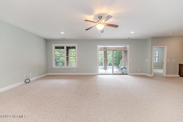 unfurnished room with ceiling fan, recessed lighting, light colored carpet, and baseboards