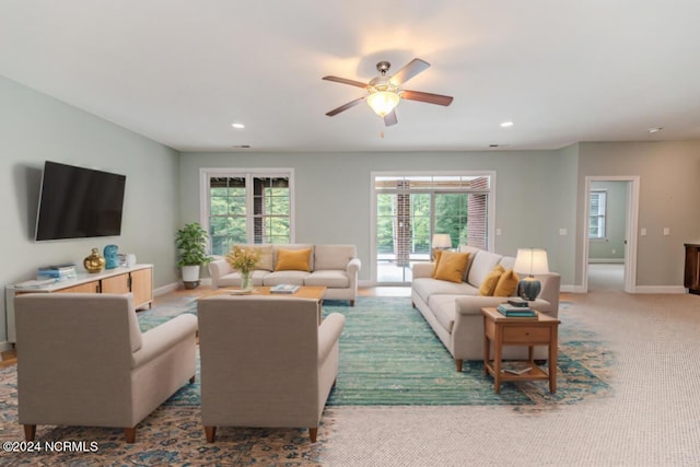 living area with a ceiling fan, recessed lighting, carpet flooring, and baseboards