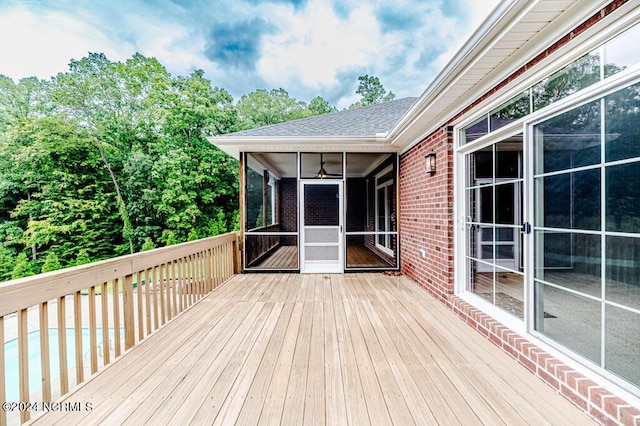 wooden deck with a sunroom