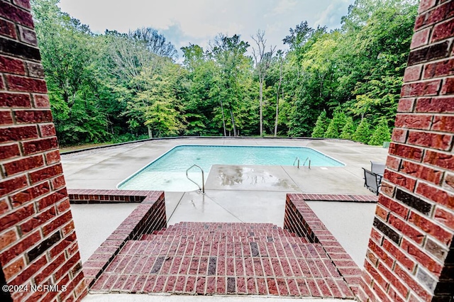 outdoor pool featuring a patio