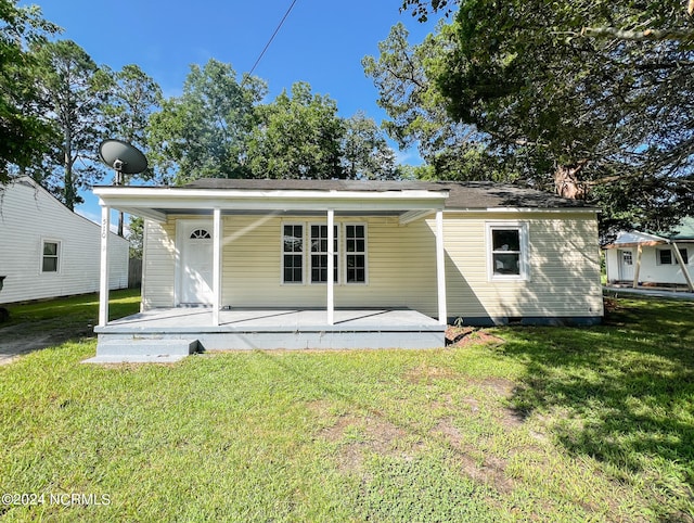 back of house with a patio and a yard