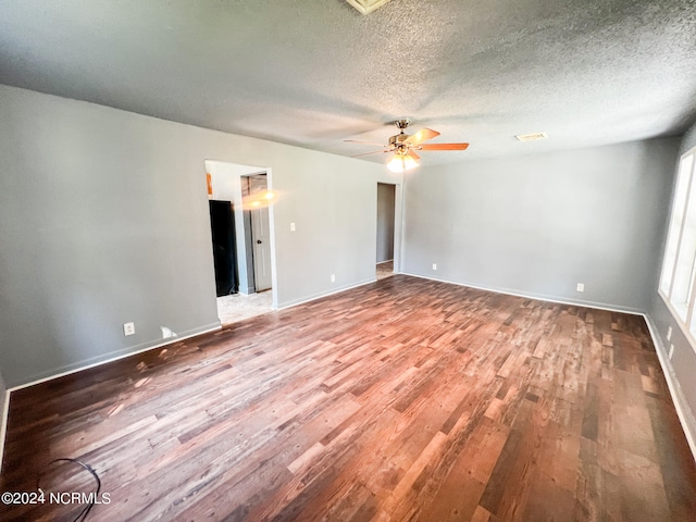 spare room with hardwood / wood-style flooring, a textured ceiling, and ceiling fan