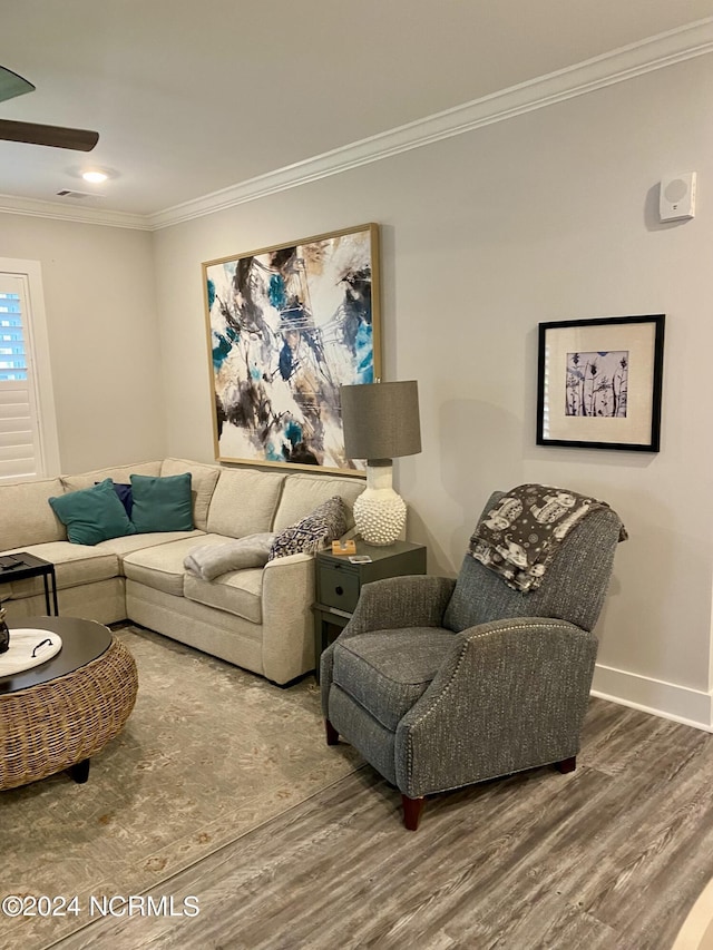 living room featuring hardwood / wood-style floors and crown molding