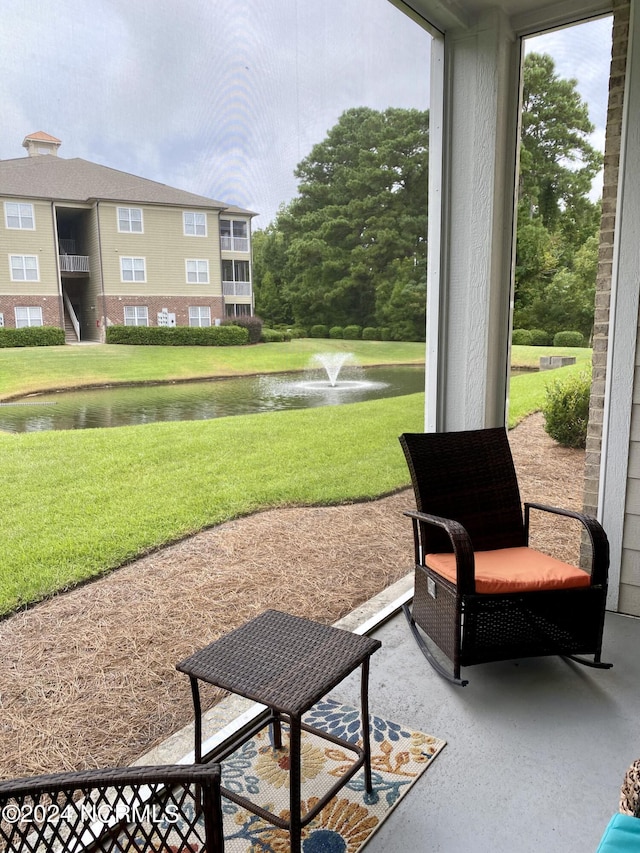 view of community featuring a water view and a yard