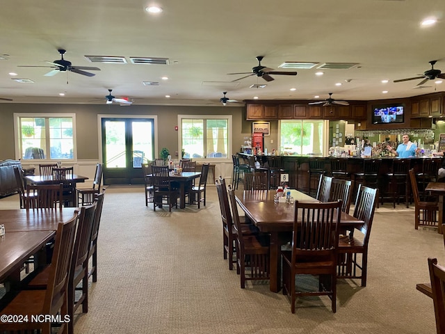 carpeted dining area featuring ornamental molding