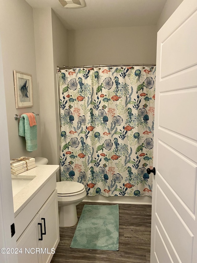 bathroom with vanity, a shower with curtain, wood-type flooring, and toilet