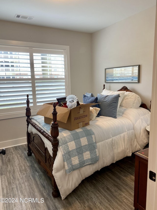 bedroom with dark wood-type flooring