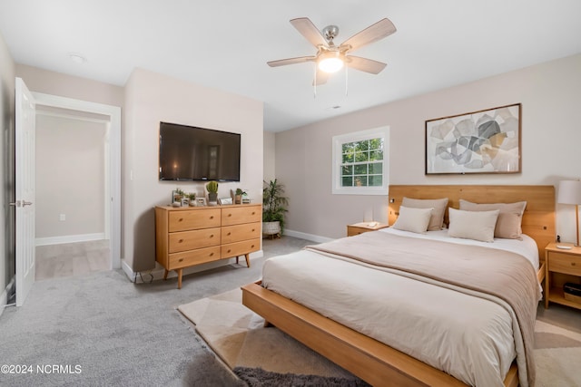 bedroom with light colored carpet and ceiling fan