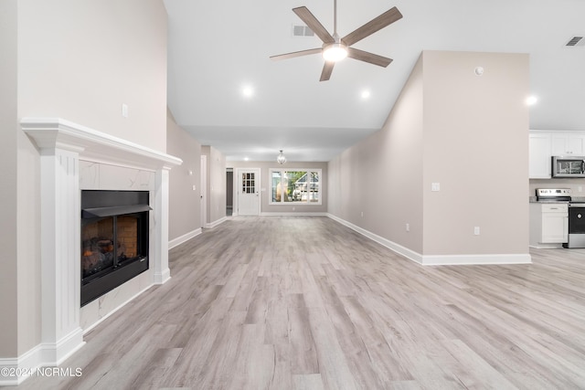 unfurnished living room with high vaulted ceiling, light hardwood / wood-style flooring, and ceiling fan