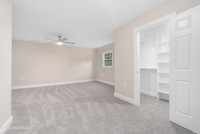 interior space featuring ceiling fan and light carpet