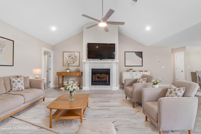 living room with ceiling fan, light hardwood / wood-style flooring, and high vaulted ceiling