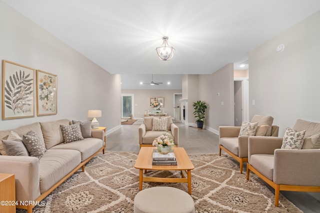 living room with ceiling fan with notable chandelier