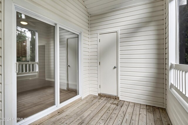 unfurnished sunroom featuring lofted ceiling