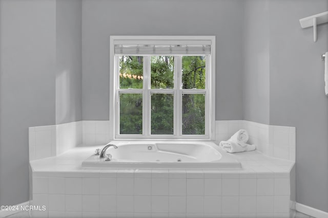 bathroom featuring a relaxing tiled tub