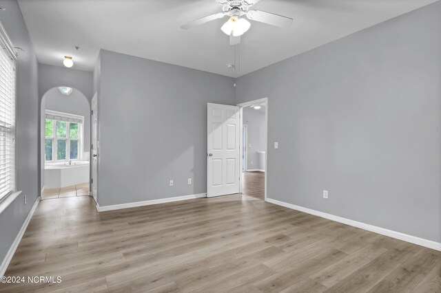 spare room with light hardwood / wood-style flooring and ceiling fan