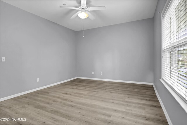 spare room featuring ceiling fan and light hardwood / wood-style floors