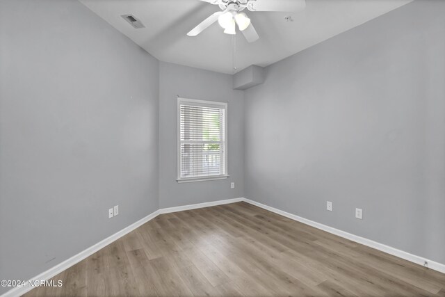 spare room with light wood-type flooring and ceiling fan