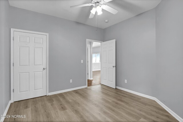 unfurnished bedroom with ceiling fan and light hardwood / wood-style floors