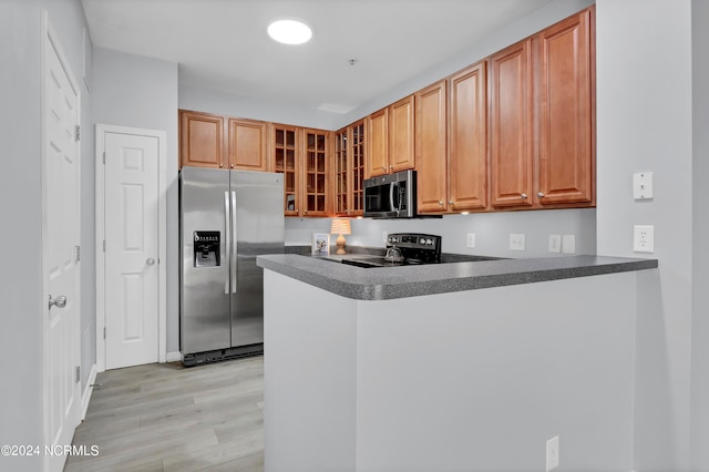 kitchen featuring kitchen peninsula, stainless steel appliances, and light hardwood / wood-style floors