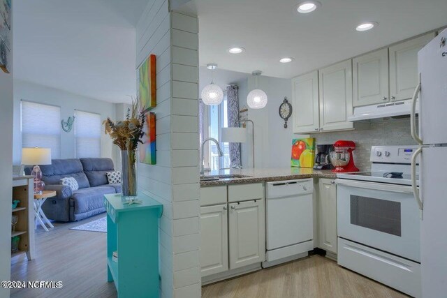 kitchen with light hardwood / wood-style floors, sink, white cabinets, and white appliances