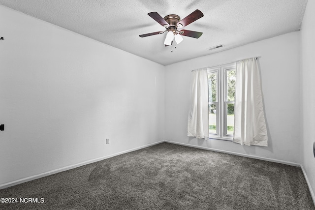 carpeted spare room with ceiling fan and a textured ceiling