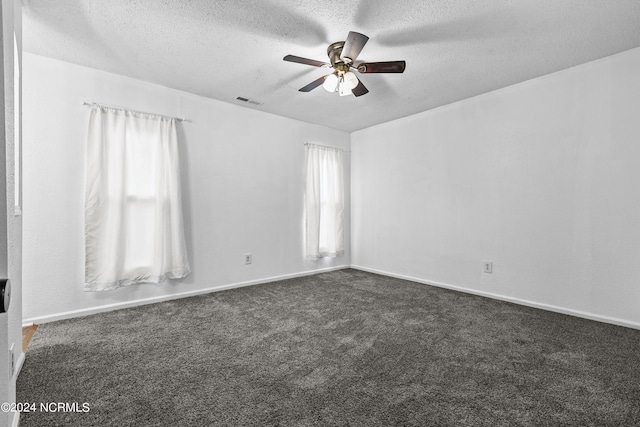 carpeted empty room with ceiling fan and a textured ceiling