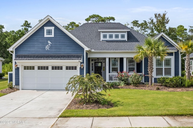 craftsman house featuring a porch, a garage, and a front lawn