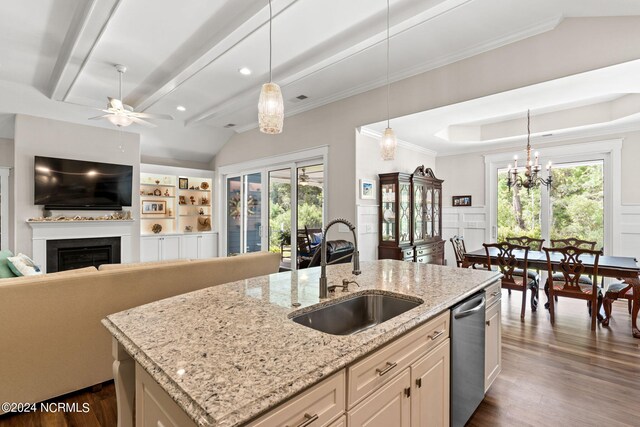 kitchen with sink, light stone counters, stainless steel dishwasher, an island with sink, and dark wood-type flooring