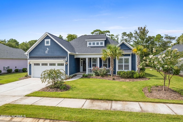 craftsman-style house featuring a porch, a garage, and a front yard