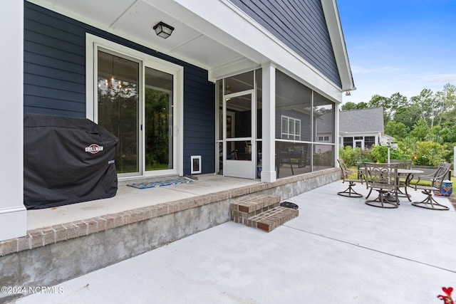 view of patio / terrace with a grill and a sunroom