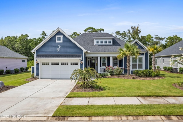 craftsman inspired home with a garage, a porch, central AC unit, and a front lawn