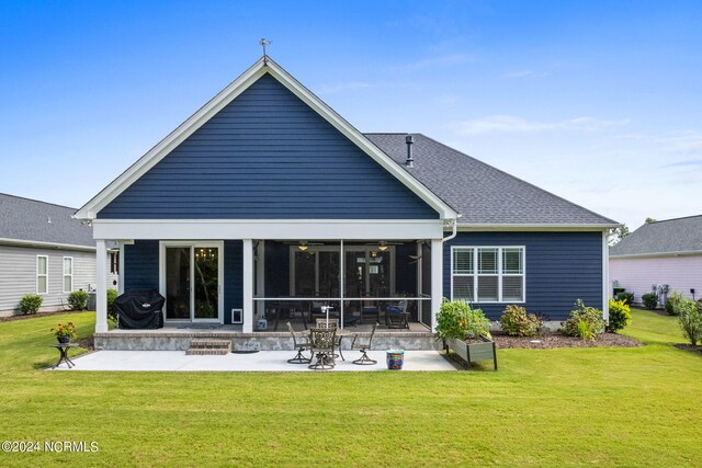 rear view of house featuring a yard and a patio area