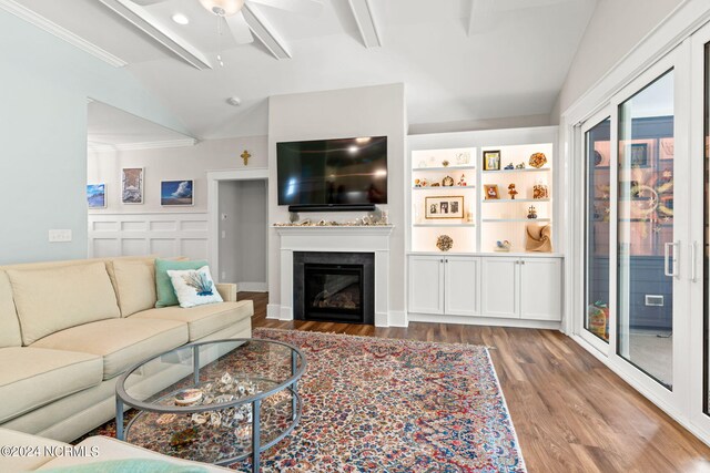 living room with vaulted ceiling with beams, ceiling fan, and light hardwood / wood-style flooring