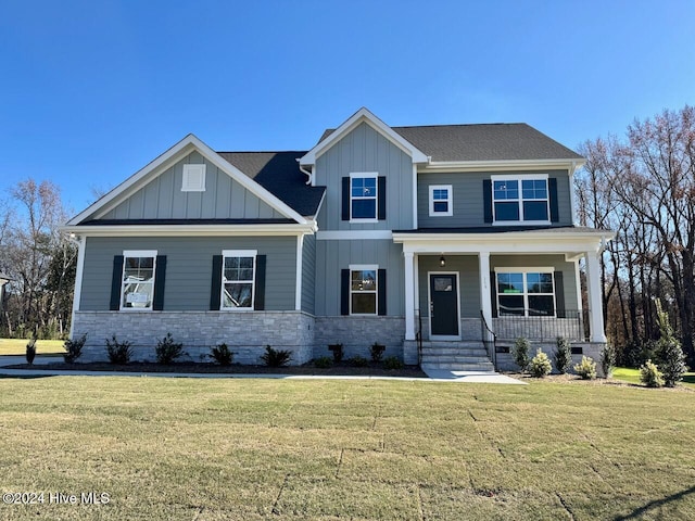 craftsman-style house featuring covered porch and a front yard