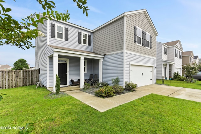 view of front of property featuring a garage and a front yard