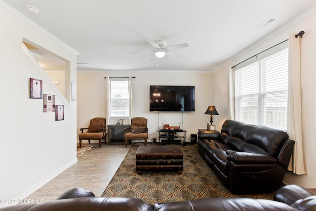 living room featuring hardwood / wood-style floors, plenty of natural light, ceiling fan, and crown molding