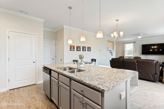 kitchen featuring a center island with sink, pendant lighting, sink, light hardwood / wood-style floors, and dishwasher